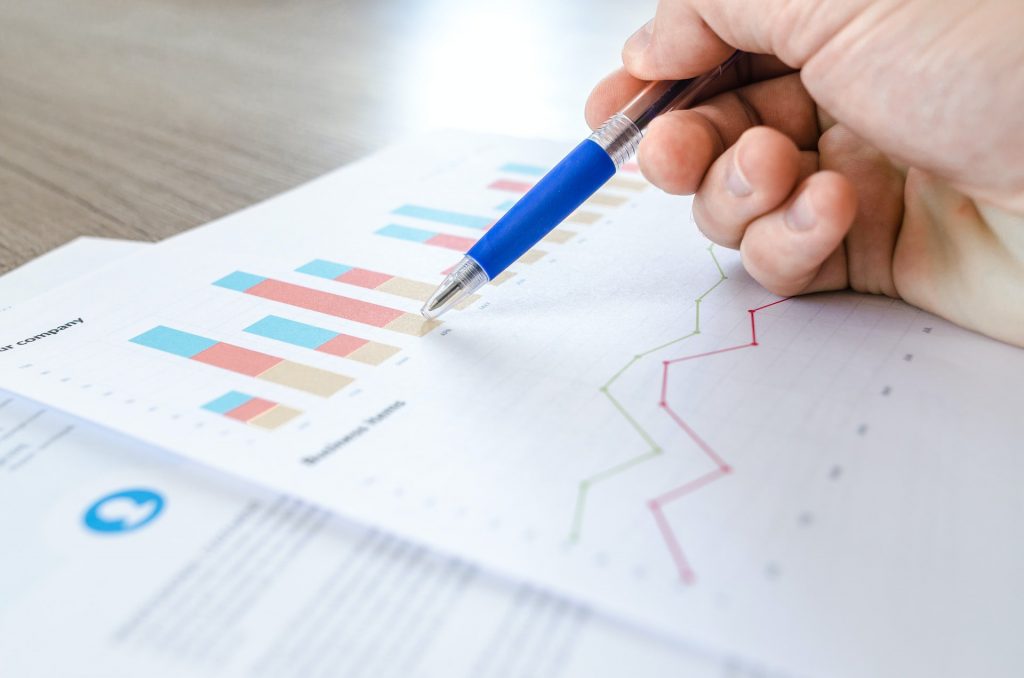 SEO analysis for website printed report. Man reviewing the report with a blue pen.