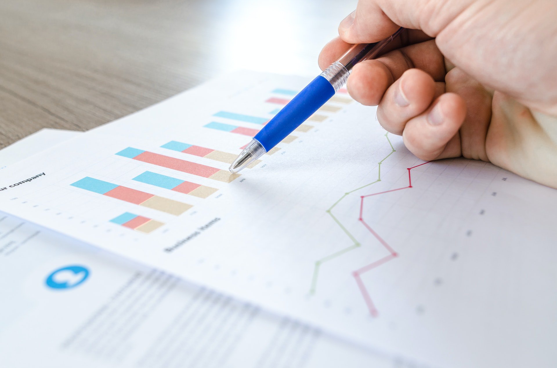SEO analysis for website printed report. Man reviewing the report with a blue pen.