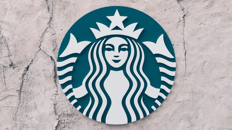Photograph of the Starbucks logo on a stucco wall.