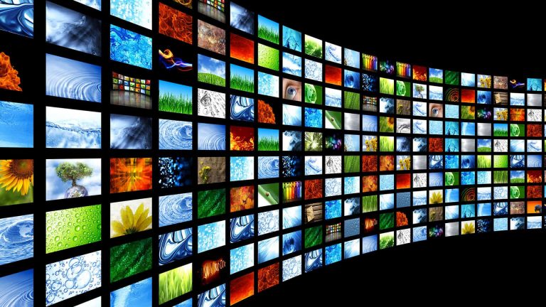 A curving wall of many video boxes with a black background.