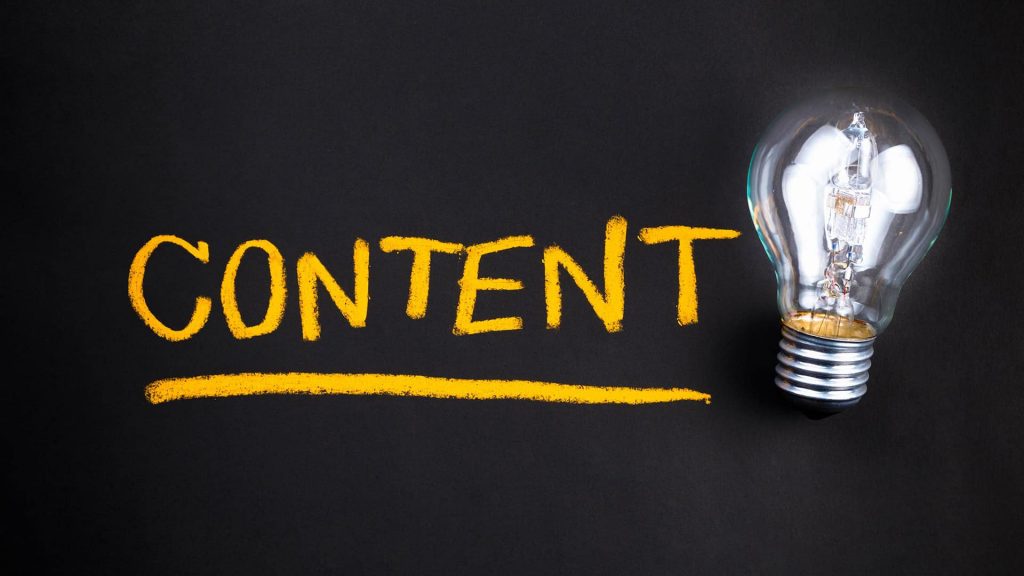 Website content with a lightbulb on a dark background.